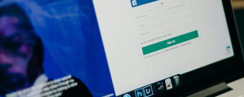 Close-up view of a laptop displaying a sign-up page for an online platform.